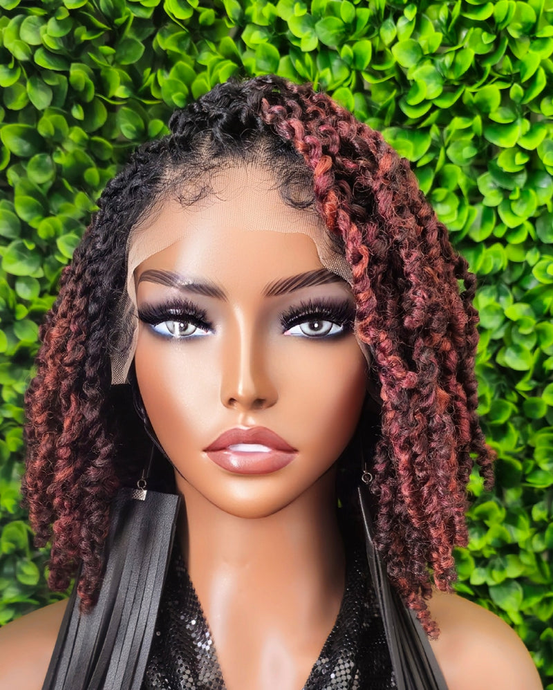 Mannequin head with styled hair against a green leafy background