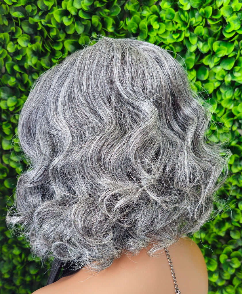 Silver hair wig against a green grass background