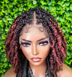 Person with styled hair against a green leafy background